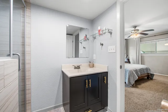 a en suite bathroom with a double vanity sink a mirror a and a shower