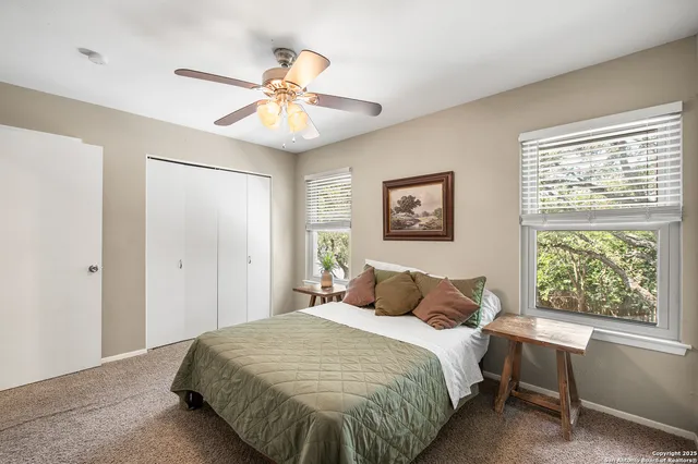 a bedroom with a large bed and a window