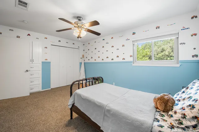 a bedroom with bed and a window