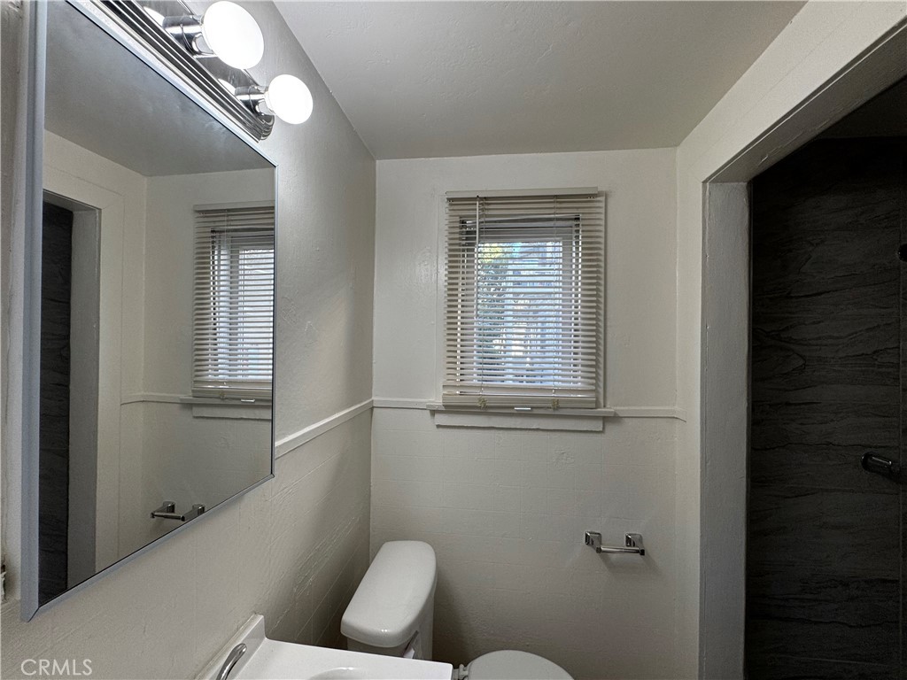 2726 5th Street, Unit 4 Riverside, CA 92507 - Photo 11 of 12 a bathroom with a toilet sink and tub