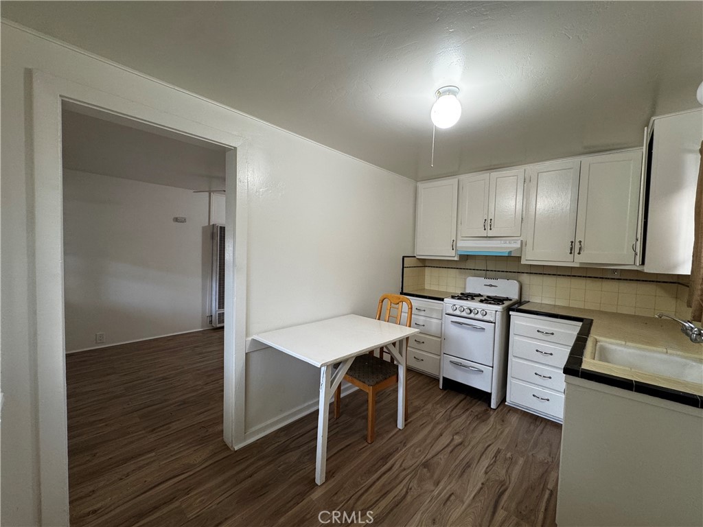 2726 5th Street, Unit 4 Riverside, CA 92507 - Photo 4 of 12 a kitchen with a sink a stove cabinets and wooden floor