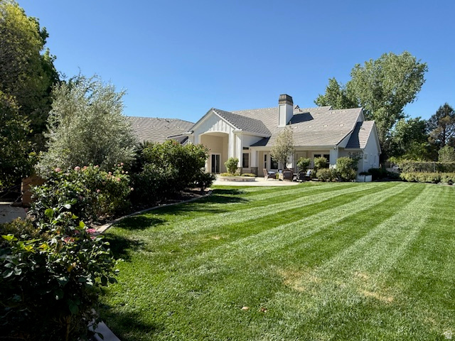 2917 Old Farm Road Washington, UT 84780 - Photo 100 of 105 View of front of house featuring a front yard, a chimney, and a patio area