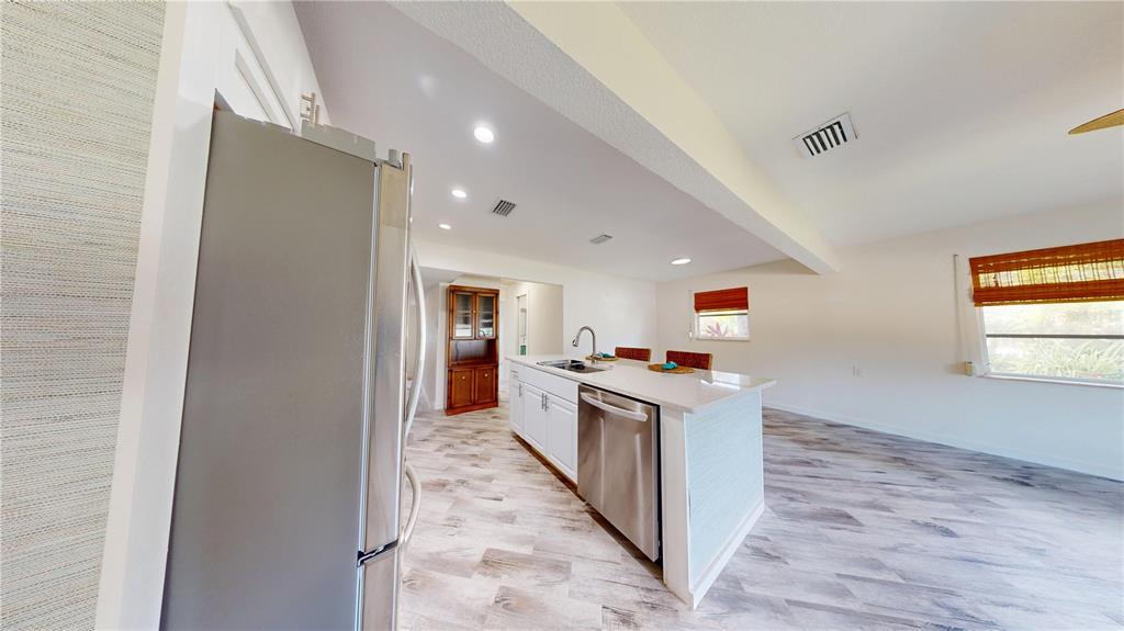 6057 Florida Street Punta Gorda, FL 33950 - Photo 14 of 29 a kitchen with a stove a refrigerator and a sink