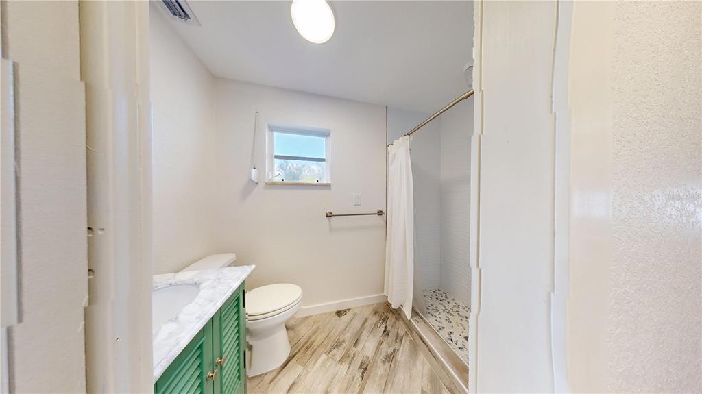 6057 Florida Street Punta Gorda, FL 33950 - Photo 17 of 29 a bathroom with a toilet a sink and shower