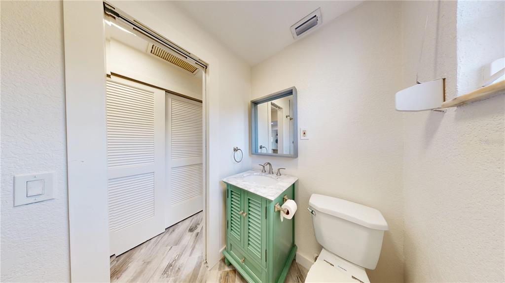 6057 Florida Street Punta Gorda, FL 33950 - Photo 18 of 29 a bathroom with a toilet sink and mirror