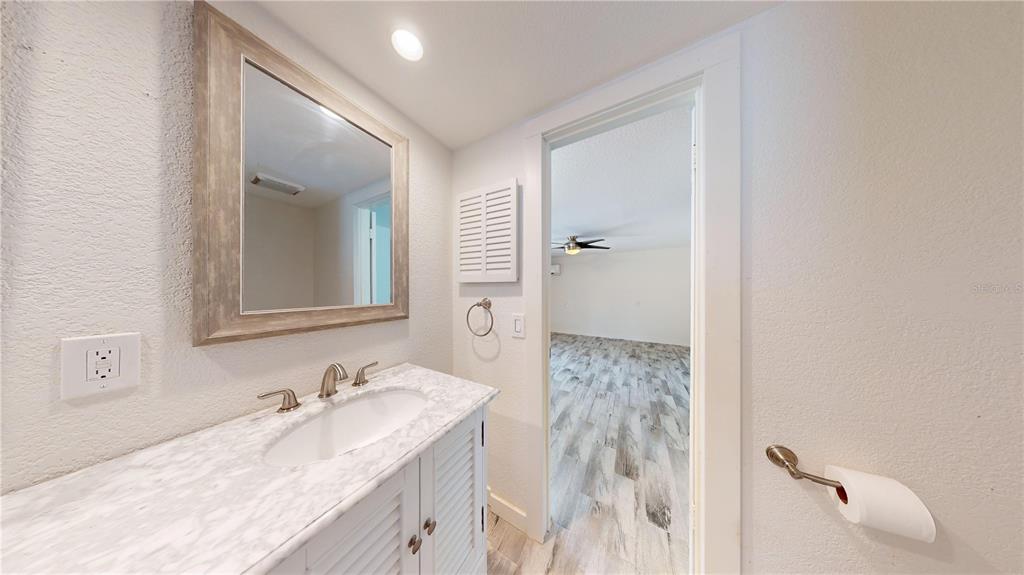 6057 Florida Street Punta Gorda, FL 33950 - Photo 23 of 29 a bathroom with a granite countertop sink and a mirror