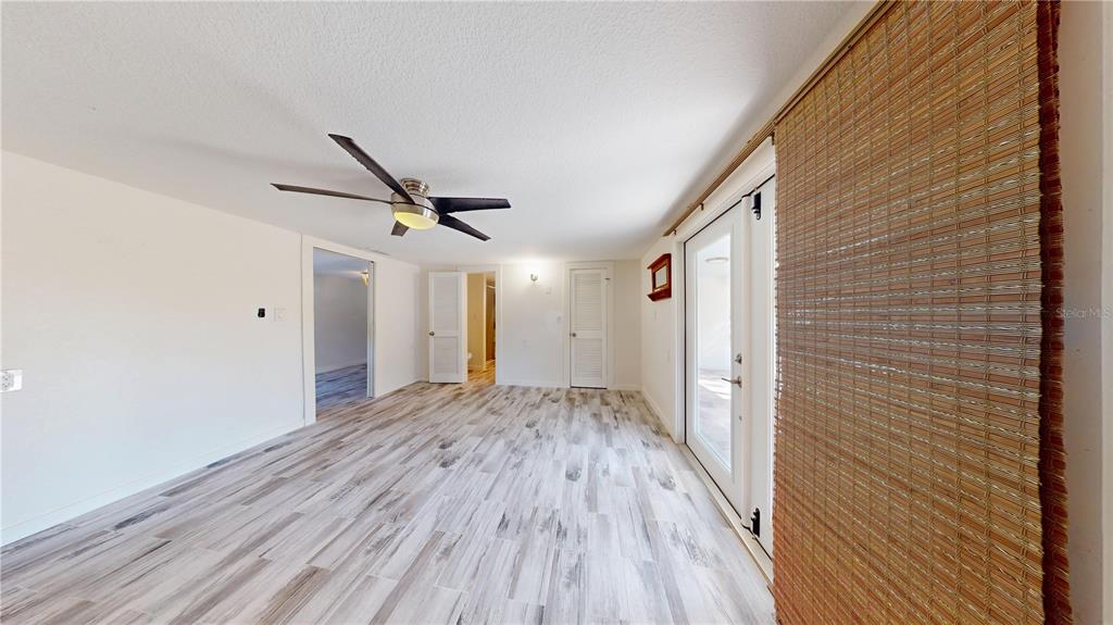 6057 Florida Street Punta Gorda, FL 33950 - Photo 26 of 29 a view of a hallway with wooden floor and a ceiling fan