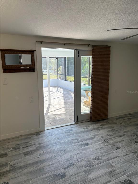 6057 Florida Street Punta Gorda, FL 33950 - Photo 29 of 29 a view of an empty room with wooden floor and a window