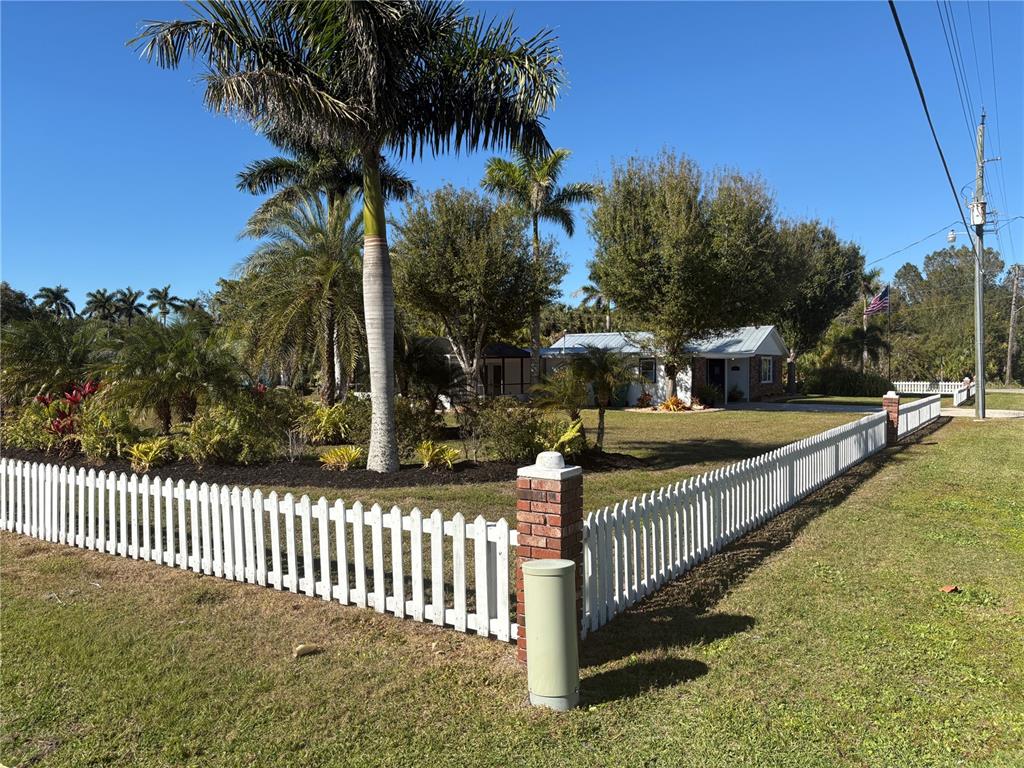 6057 Florida Street Punta Gorda, FL 33950 - Photo 5 of 29 a view of a street with wooden fence