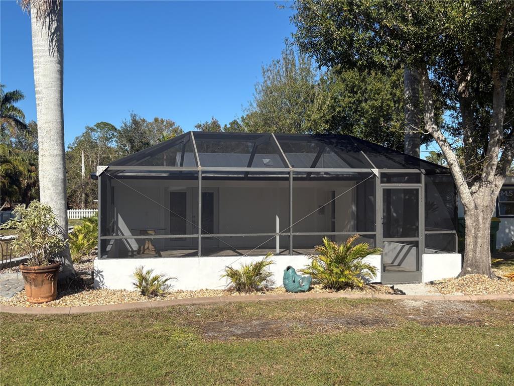 6057 Florida Street Punta Gorda, FL 33950 - Photo 7 of 29 a front view of a house with a garden
