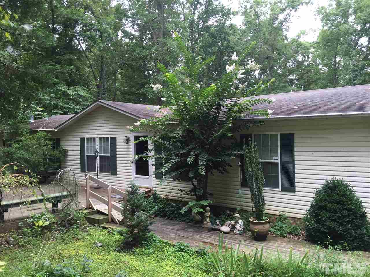 1136 Holeman Ashley Road Timberlake, NC 27583 - Photo 1 of 20 a view of a house with a yard plants and large tree