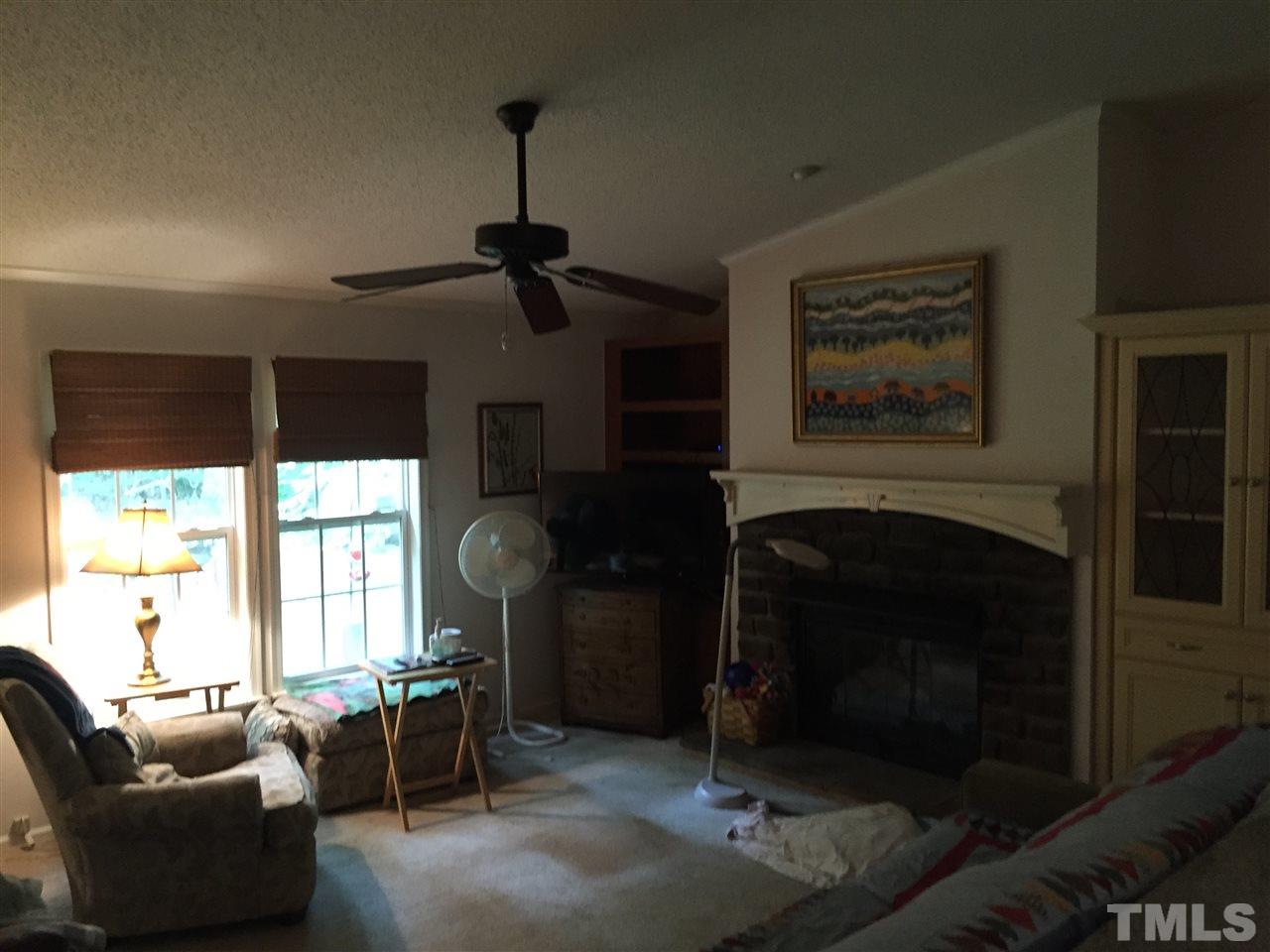 1136 Holeman Ashley Road Timberlake, NC 27583 - Photo 11 of 20 a living room with furniture a window and a fireplace