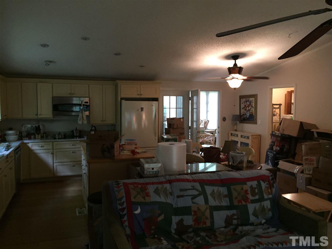 1136 Holeman Ashley Road Timberlake, NC 27583 - Photo 13 of 20 a kitchen with sink dining table and chairs