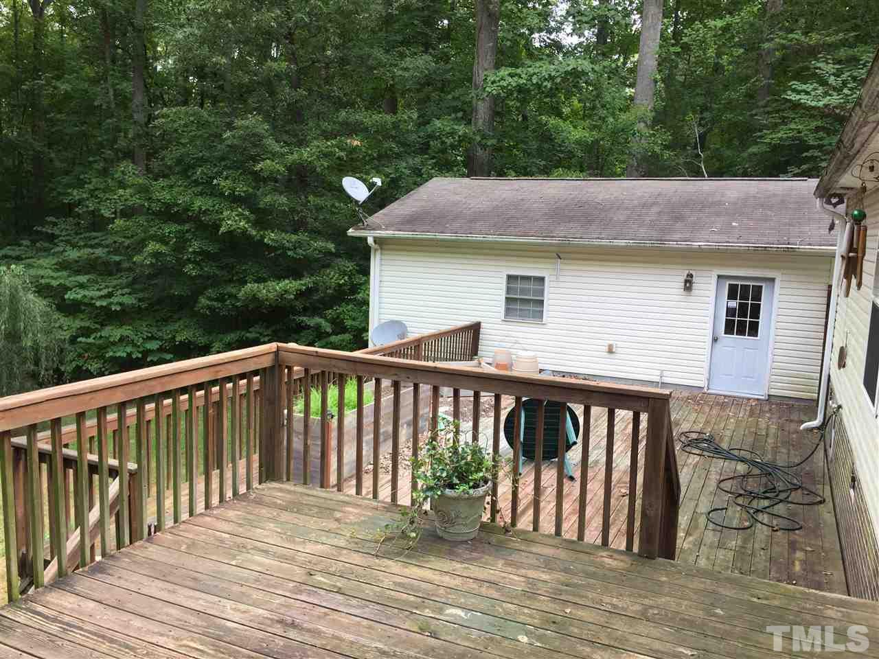 1136 Holeman Ashley Road Timberlake, NC 27583 - Photo 16 of 20 a roof deck that has a table and chairs