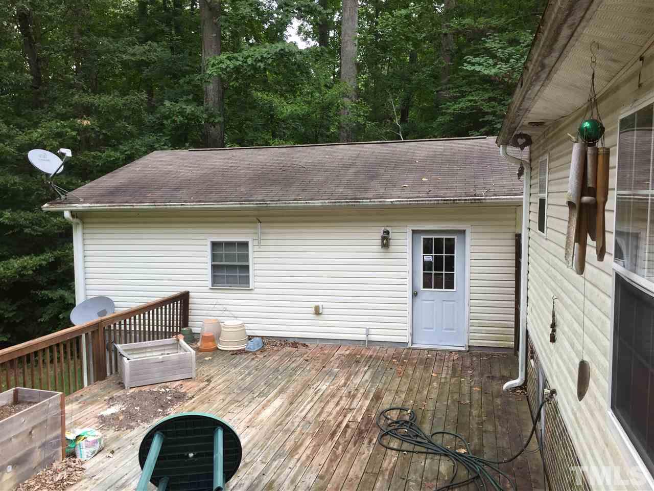 1136 Holeman Ashley Road Timberlake, NC 27583 - Photo 18 of 20 a view of house with backyard space and seating