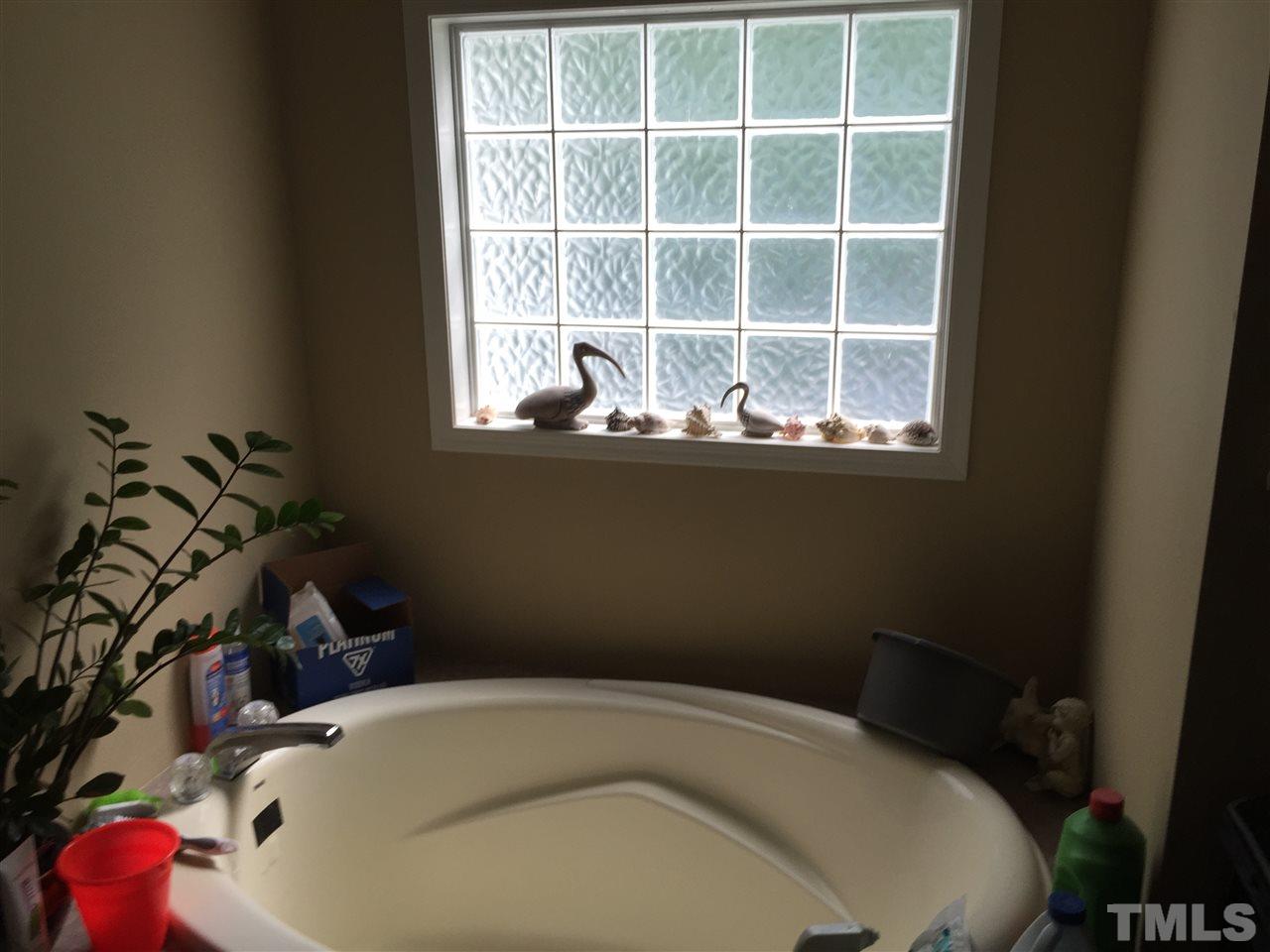 1136 Holeman Ashley Road Timberlake, NC 27583 - Photo 9 of 20 a bathroom with a bathtub and sink