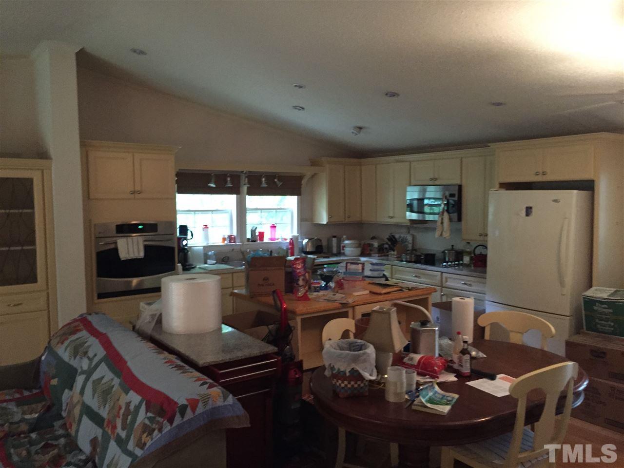 1136 Holeman Ashley Road Timberlake, NC 27583 - Photo 10 of 20 a kitchen with a dining table and chairs