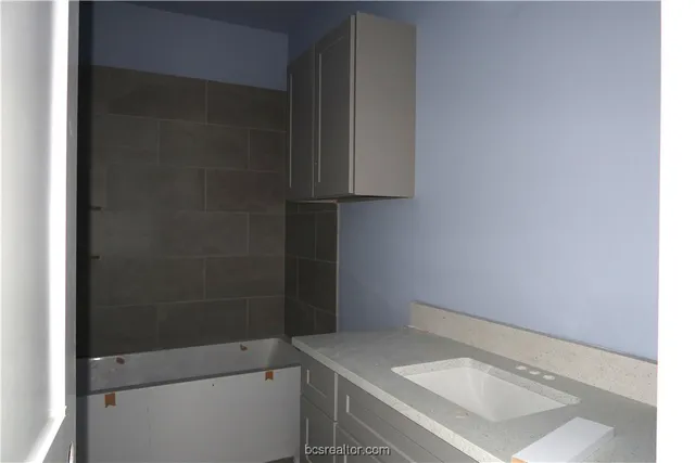 a bathroom with a sink and vanity