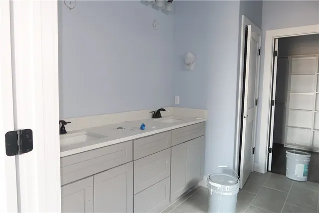 a spacious bathroom with a double vanity sink toilet and shower