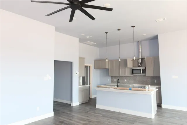 a kitchen with kitchen island white cabinets and stainless steel appliances