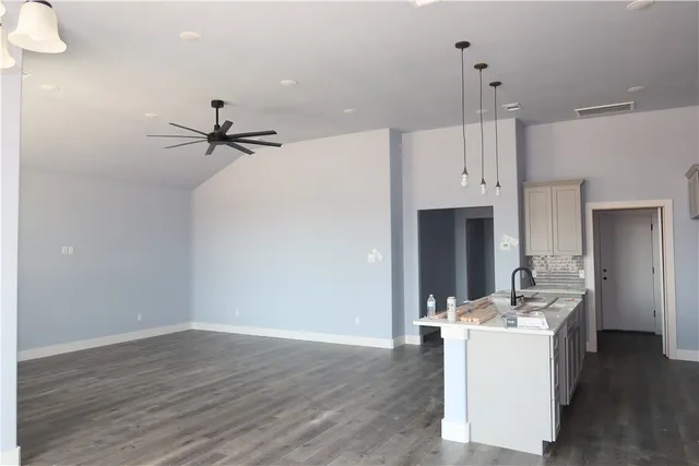 a living room with a sink furniture and a wooden floor