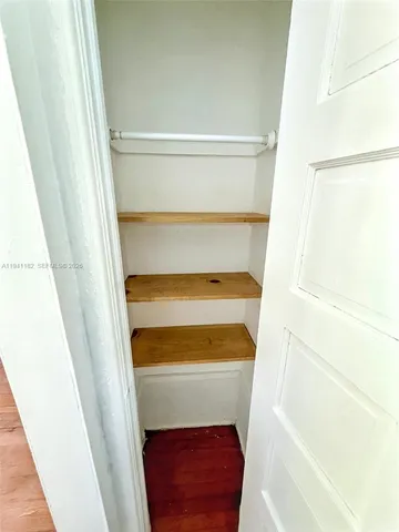 a view of walk in closet with empty racks