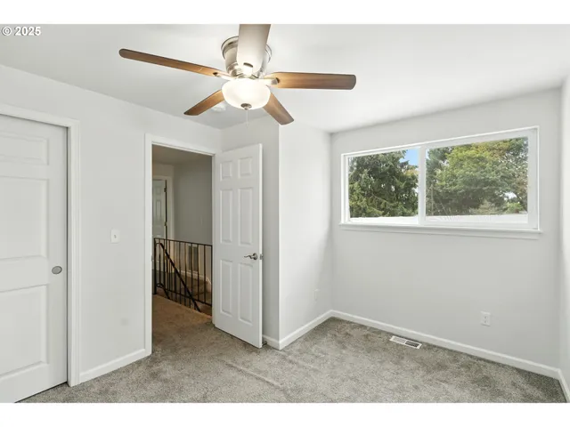 a view of a livingroom with a ceiling fan and a window