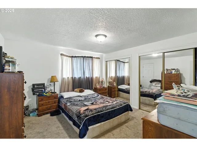 a bedroom with a bed and a dresser