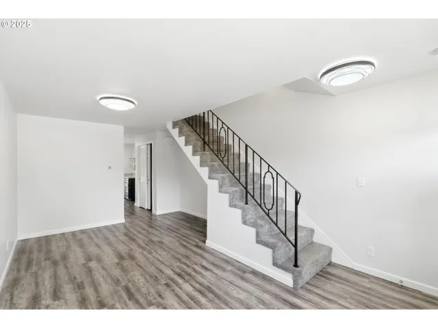 a view of an entryway with wooden floor