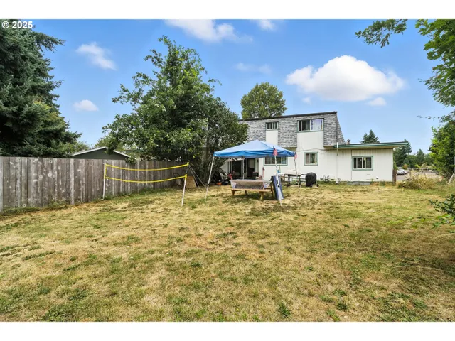 a swimming pool with outdoor seating and yard