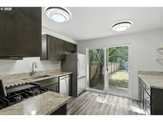 a kitchen with a stove a refrigerator and a sink