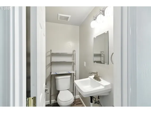 a bathroom with a sink toilet and mirror
