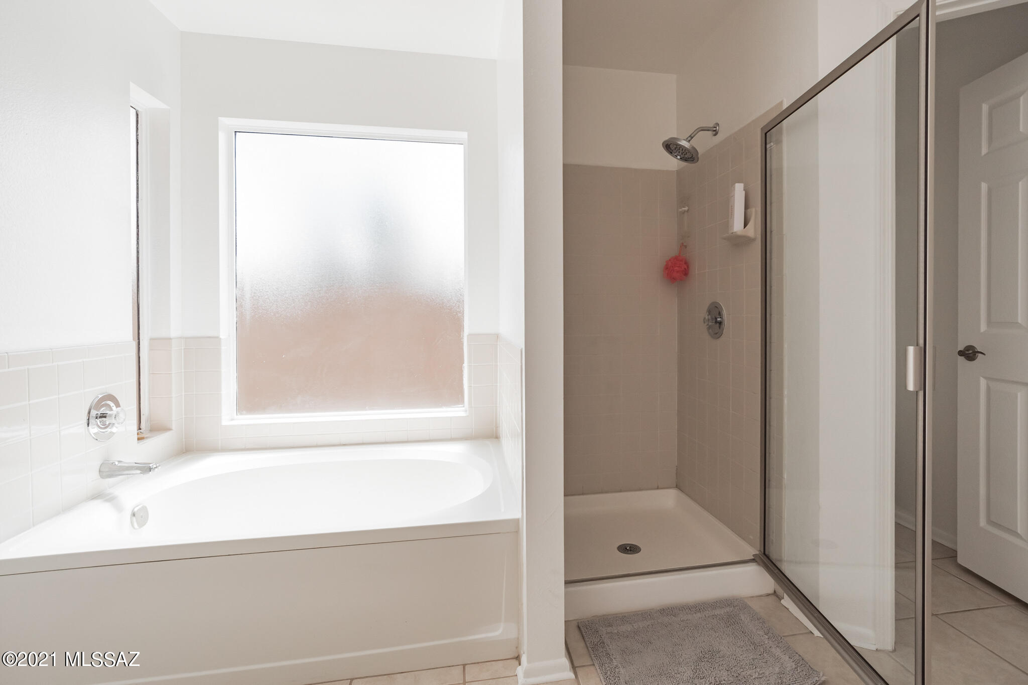 9671 East Azuma Way Tucson, AZ 85747 - Photo 18 of 31 a bathroom with a shower and a sink