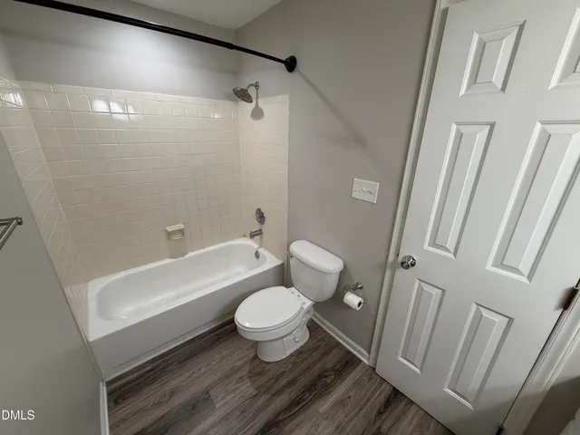 a bathroom with a toilet and a bathtub