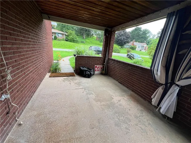a front view of a house with a yard and green space