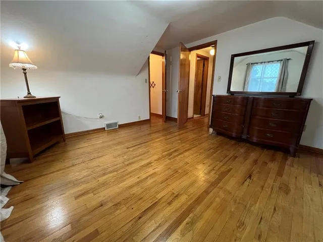 a view of an empty room and wooden floor