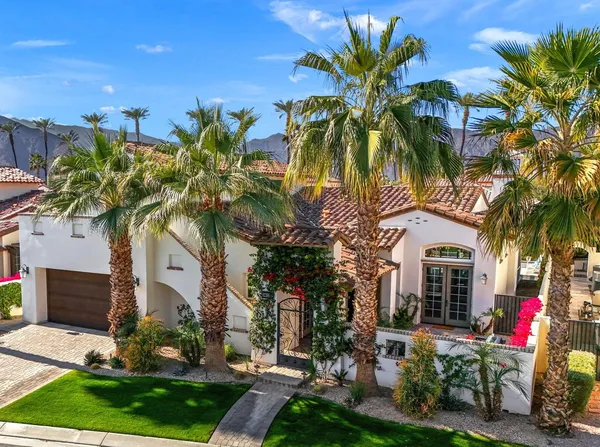 a view of a palm trees in front of a house