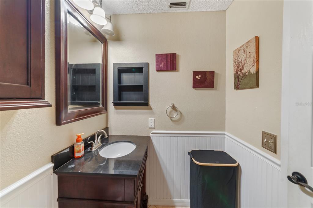 8715 Huntsman Lane Port Richey, FL 34668 - Photo 38 of 54 a bathroom with a sink and a mirror