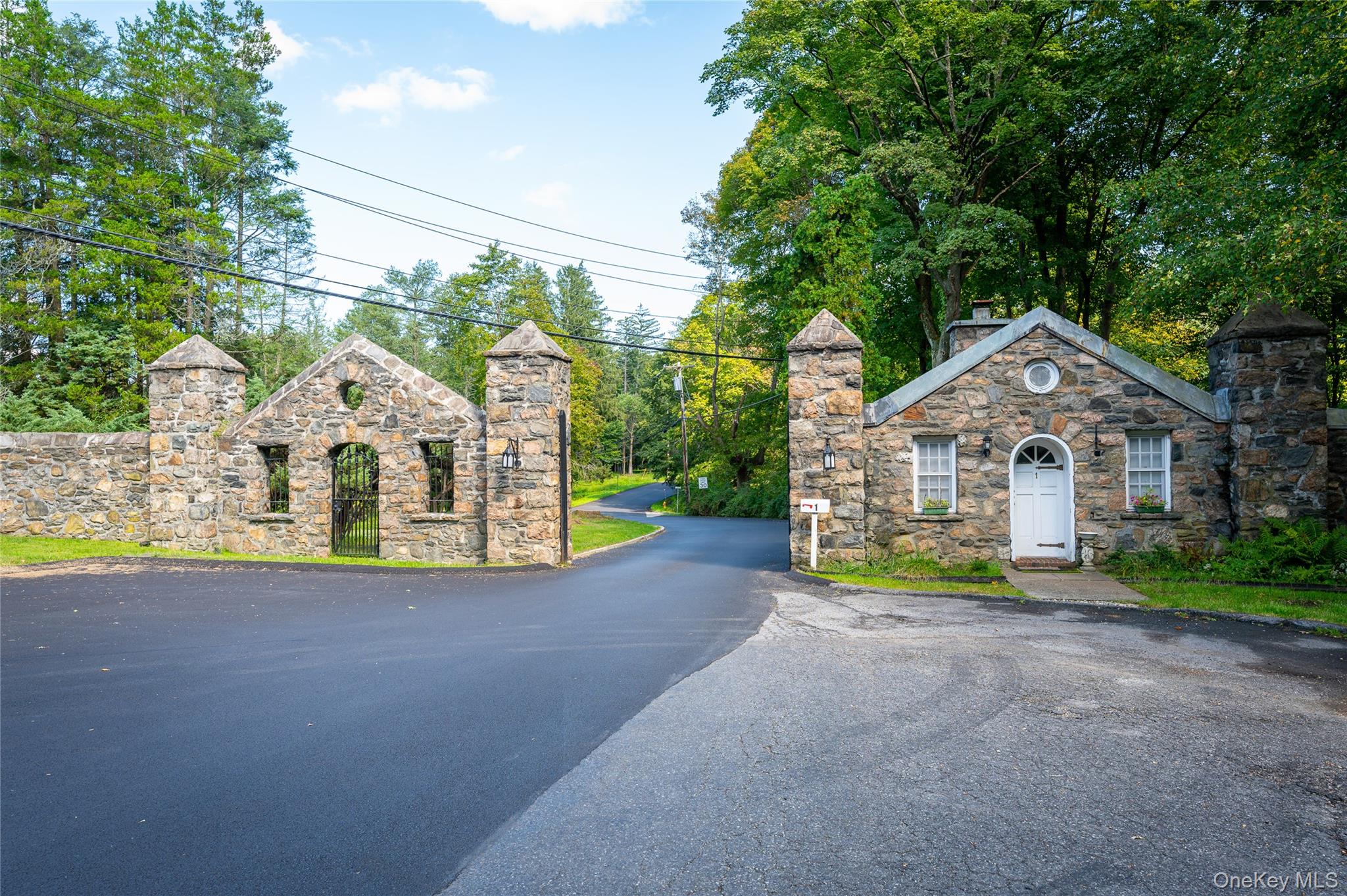 65 Windmill Road Armonk, NY 10504 - Photo 30 of 37 a front view of a house with a garden and trees
