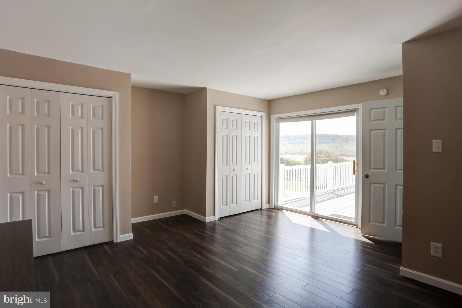 680 Powells Valley Road Halifax, PA 17032 - Photo 17 of 44 a view of an empty room with wooden floor and a window