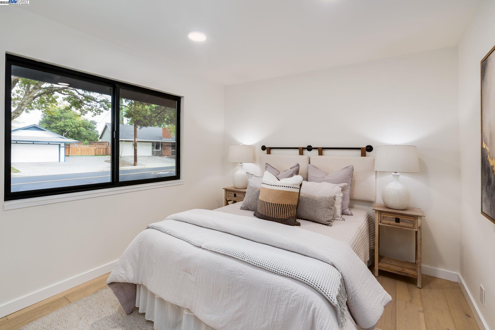 1425 Camino Verde Walnut Creek, CA 94597 - Photo 14 of 28 a bedroom with a large bed and a large window
