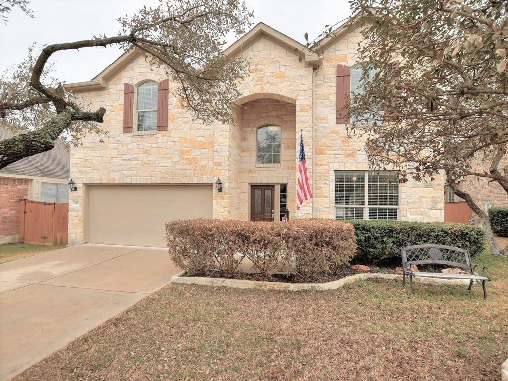 a front view of a house with a yard and garage