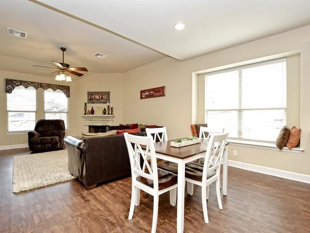 a view of a dining room with furniture and a large window