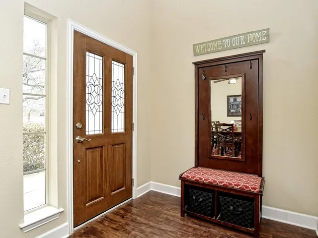 a hallway with a couch next to a window