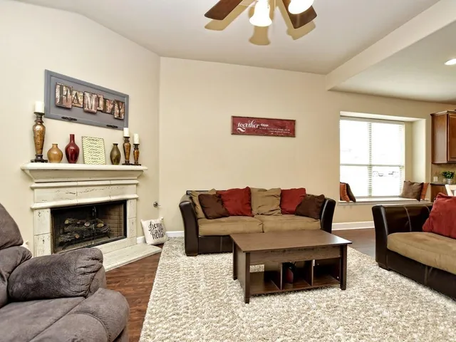 a living room with furniture and a fireplace