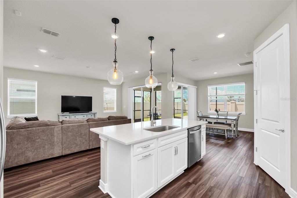 2001 Spring Shower Circle Kissimmee, FL 34744 - Photo 8 of 25 a large kitchen with stainless steel appliances kitchen island a large counter top a sink a stove and a refrigerator
