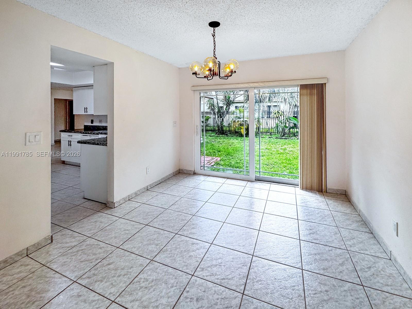 6802 Southwest 34th Court Miramar, FL 33023 - Photo 13 of 41 a view of a kitchen with an empty room and a window