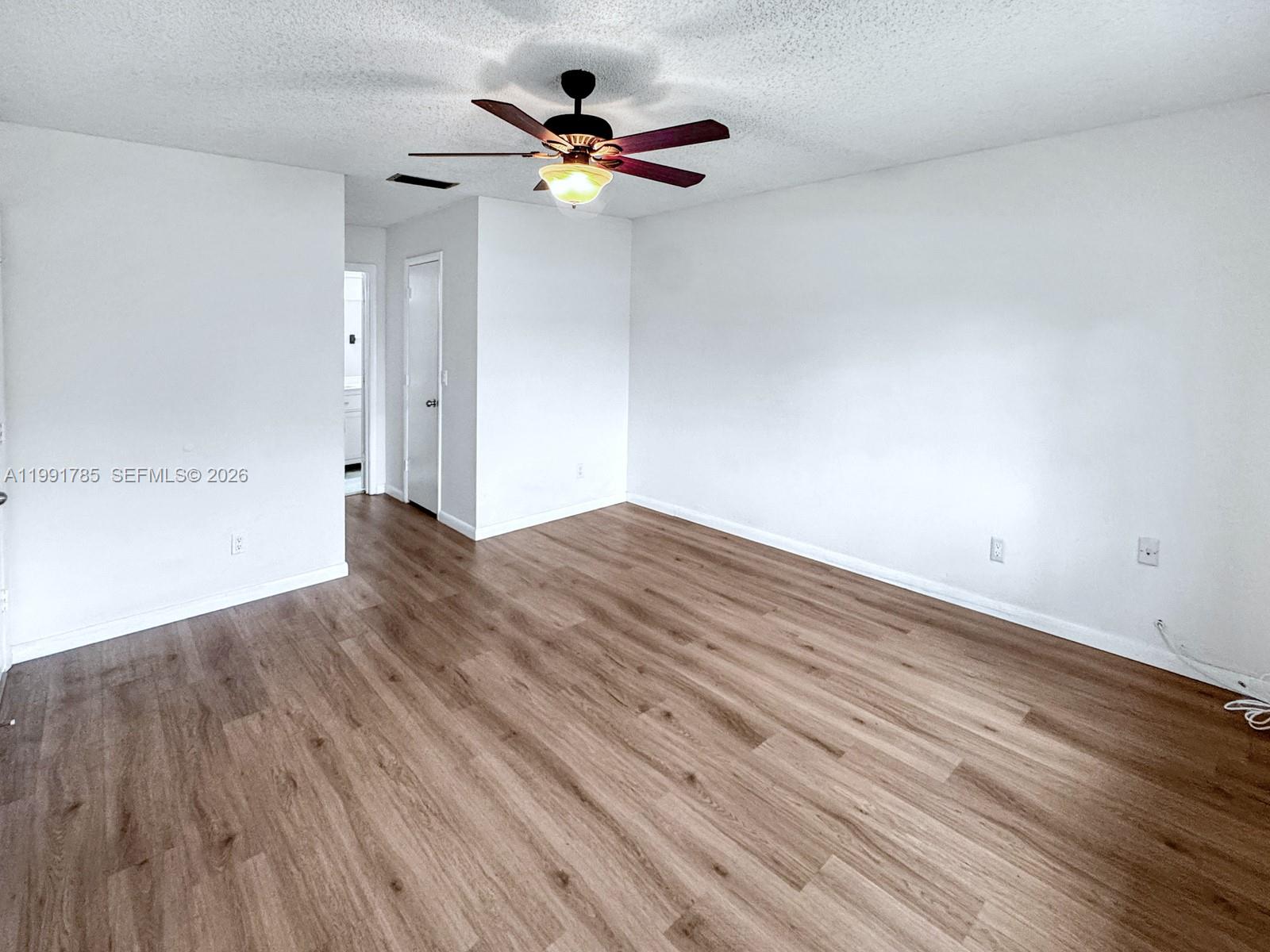 6802 Southwest 34th Court Miramar, FL 33023 - Photo 20 of 41 a view of an empty room with wooden floor