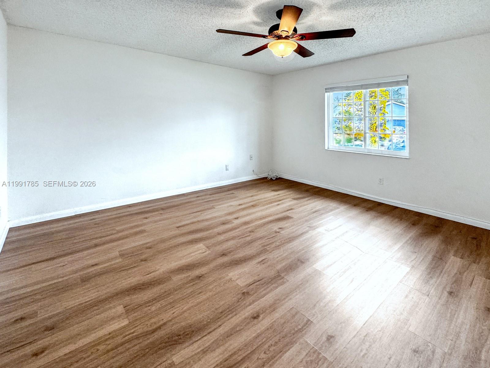 6802 Southwest 34th Court Miramar, FL 33023 - Photo 21 of 41 wooden floor in an empty room with a window