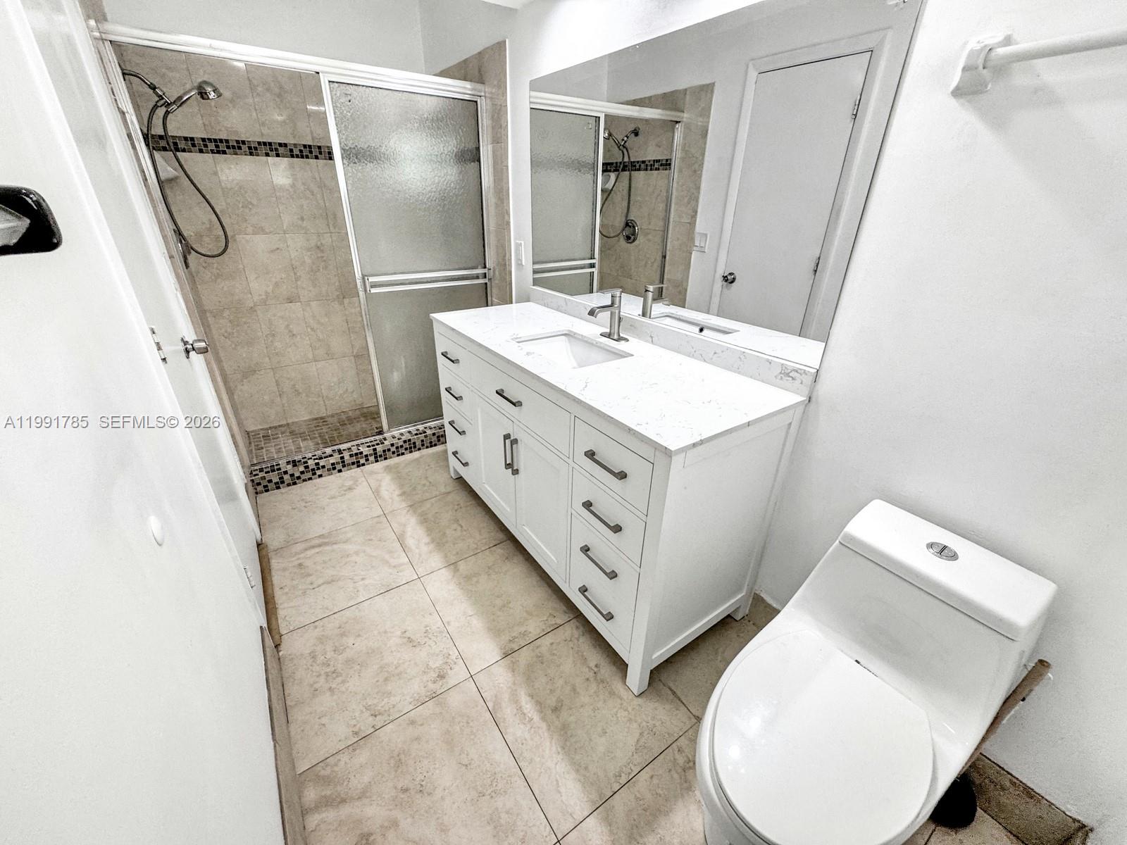 6802 Southwest 34th Court Miramar, FL 33023 - Photo 23 of 41 a bathroom with a sink mirror and a shower